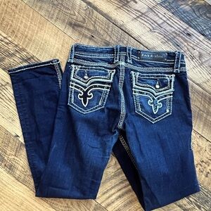 Rock Revival straight leg Jean. Black sequin back pocket embellishment.